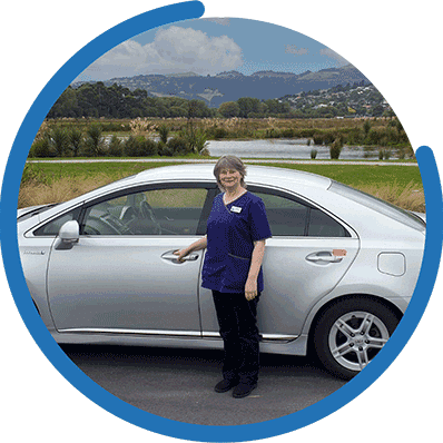 Kathryn, owner of Lifestyle Companions, standing by her car